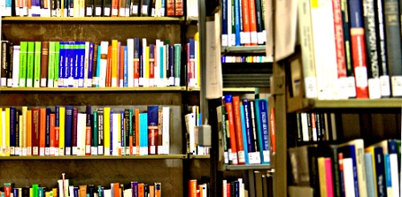 books on a library shelf, by Jennifer Schröder